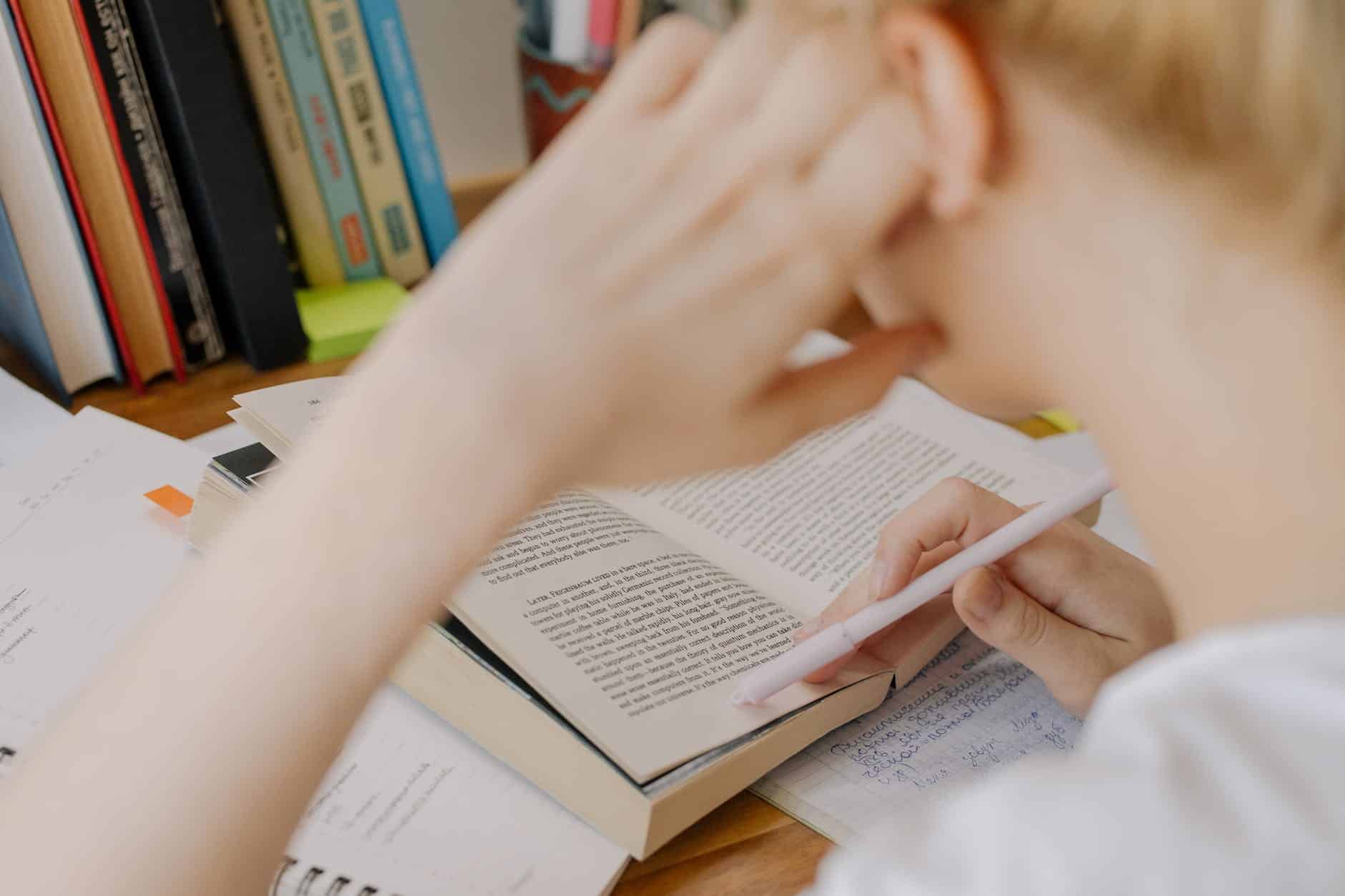 child writing on white paper