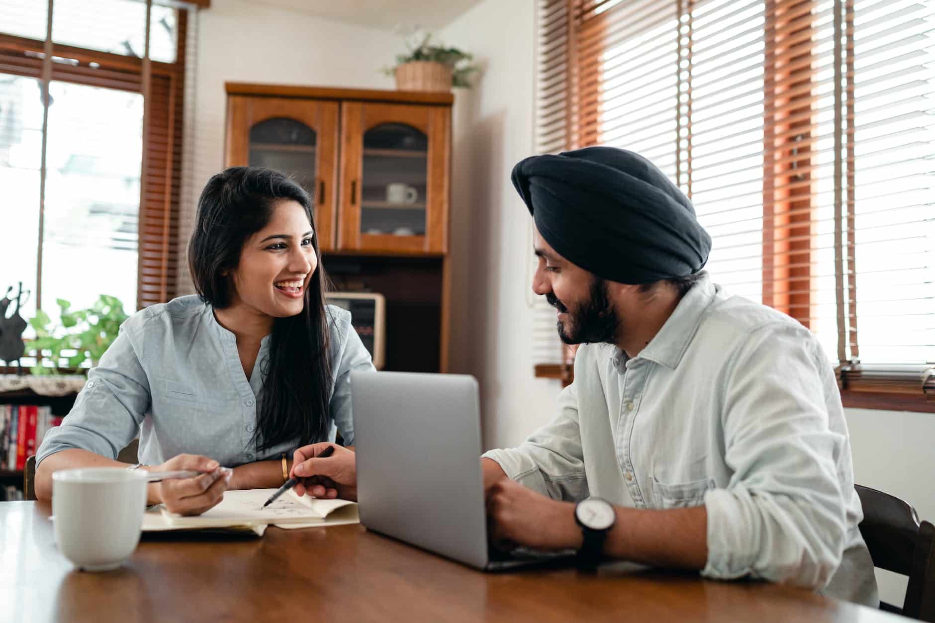 cheerful couple discussing business issues at home