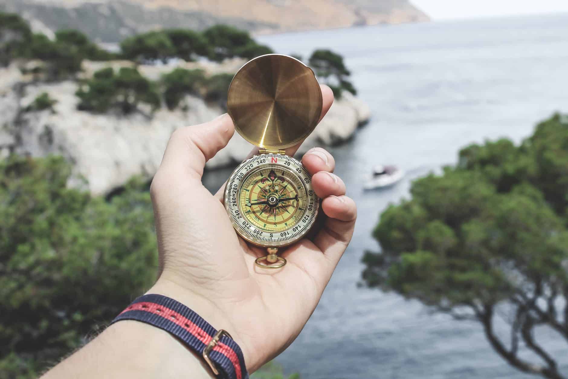 person holding compass